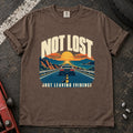 Espresso T-shirt showing a car on a sunset road with 'Not lost. Just leaving evidence'.