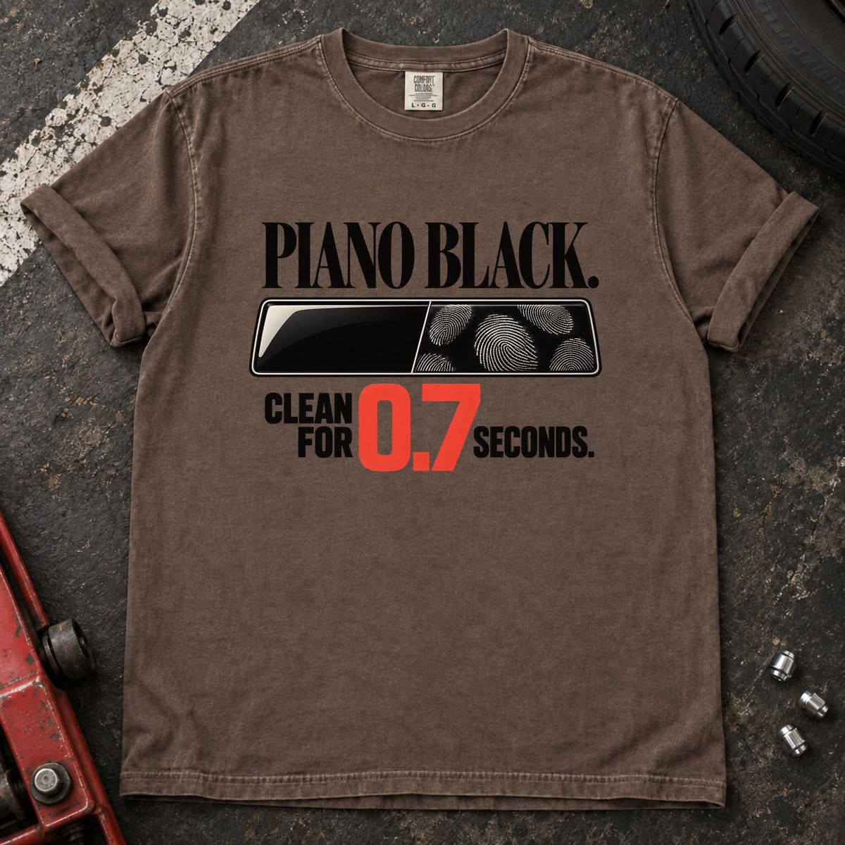 Espresso T-shirt showing fingerprints on a trim panel with 'Piano black. Clean for 0.7 seconds'.