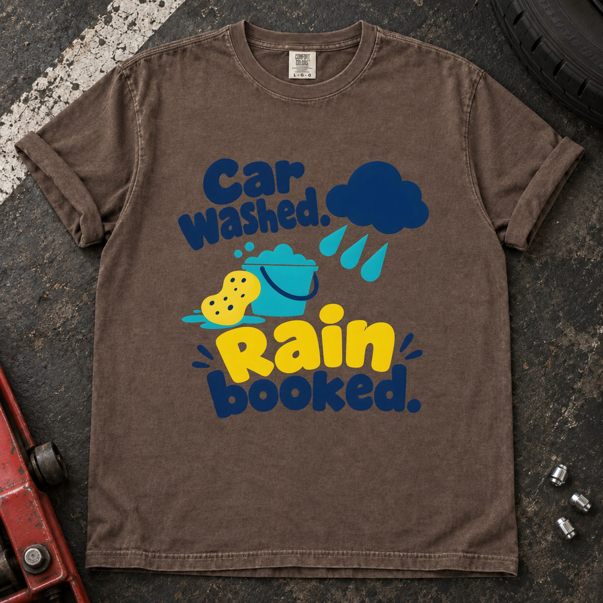 Espresso T-shirt showing a rain cloud, droplets and cleaning sponge with 'Car washed. Rain booked'.