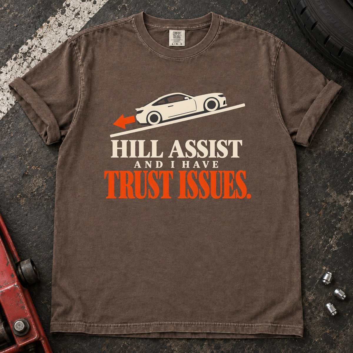 Espresso T-shirt showing a car on a slope with 'Hill assist and I have trust issues'.