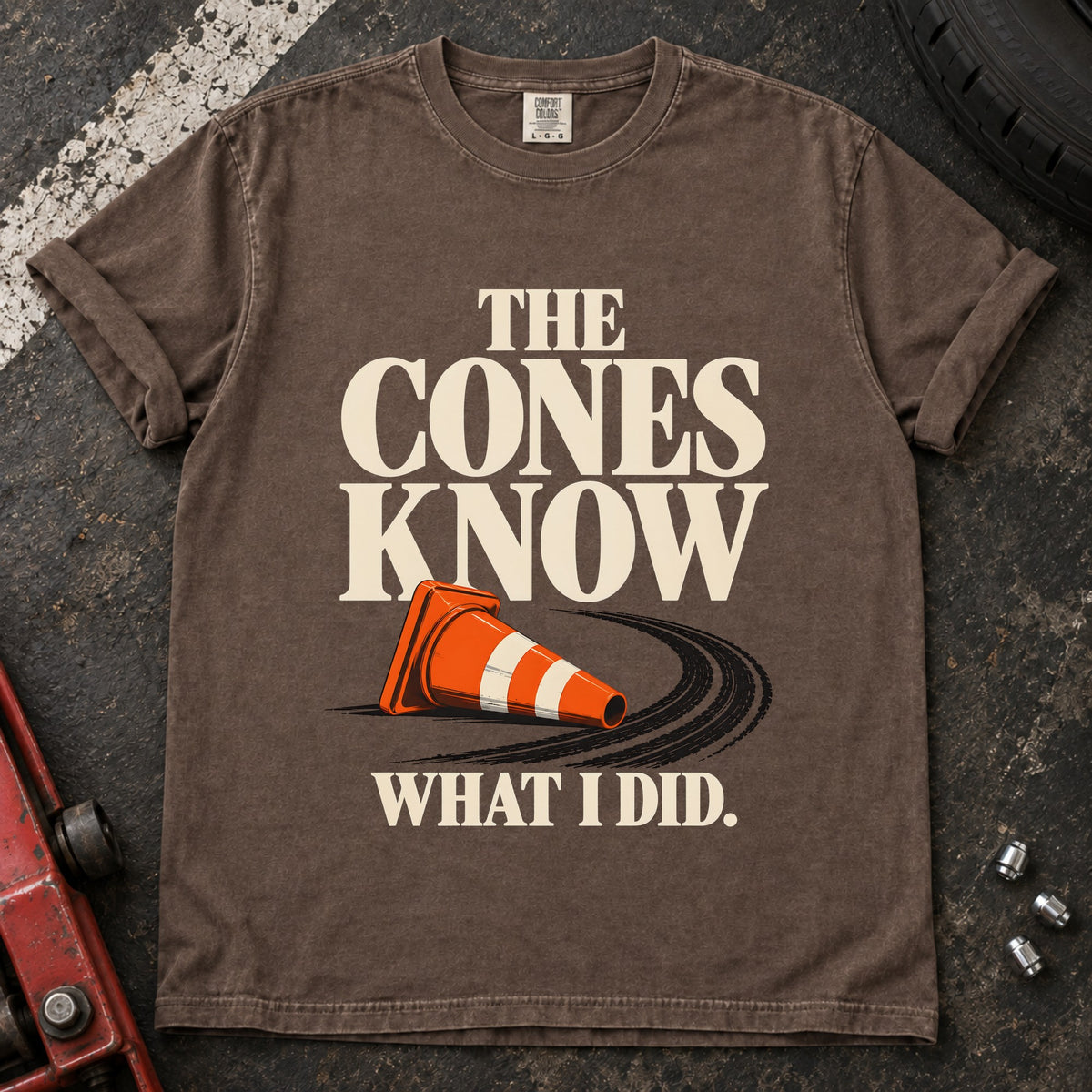 Espresso T-shirt showing a fallen orange traffic cone with 'The cones know what I did'.