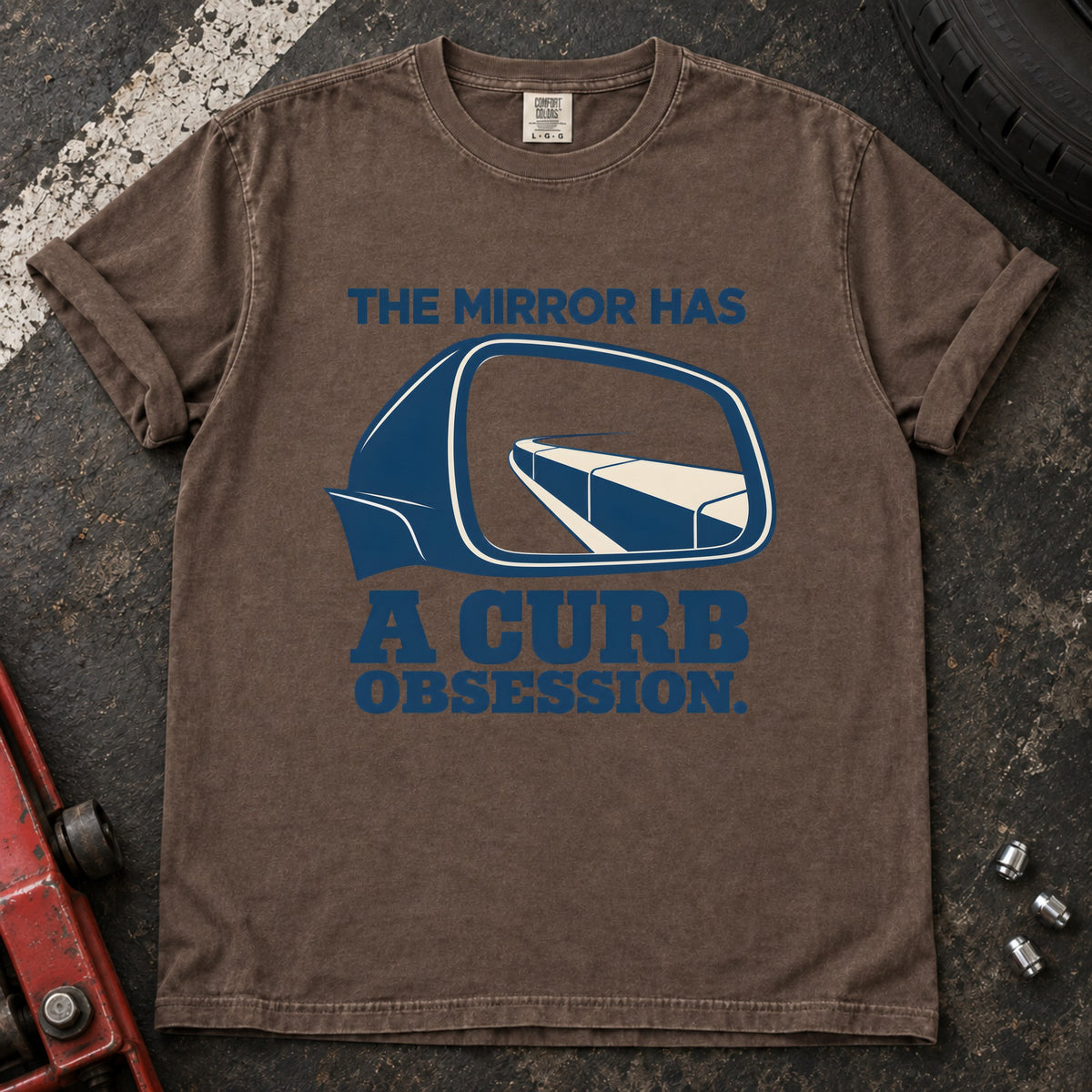 Espresso T-shirt showing a side mirror reflecting a curb with 'The mirror has a curb obsession'.