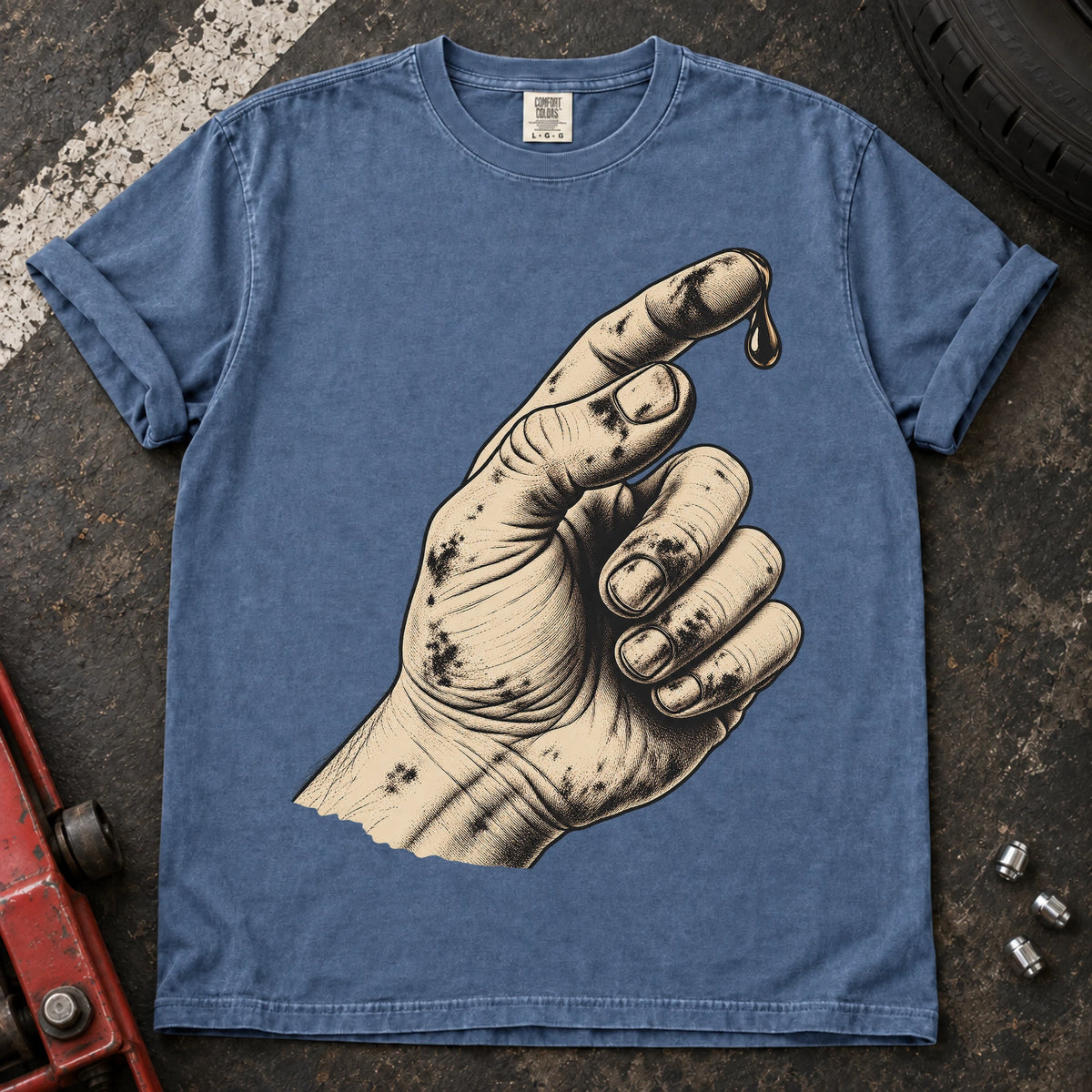 Blue Jean car enthusiast T-shirt. An oily hand examines a drop of fluid in a text-free maintenance illustration.