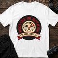 White gaming T-shirt. A tire-ring badge combines checkered flags with redline-or-nothing attitude.