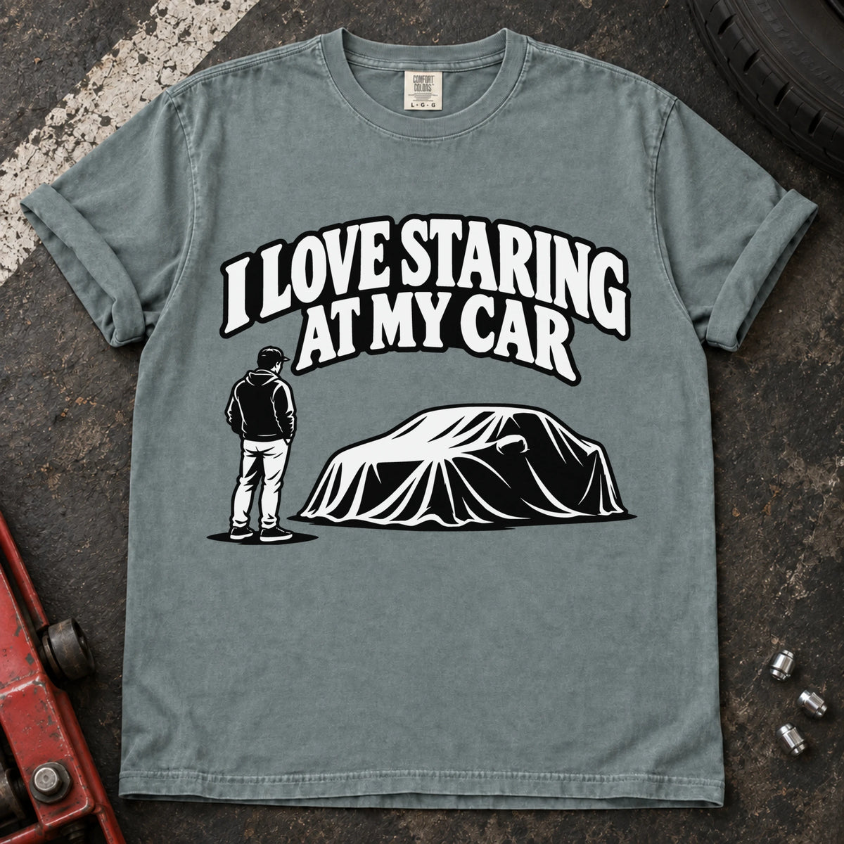 Bay T-shirt showing a person beside a covered car under 'I love staring at my car'.