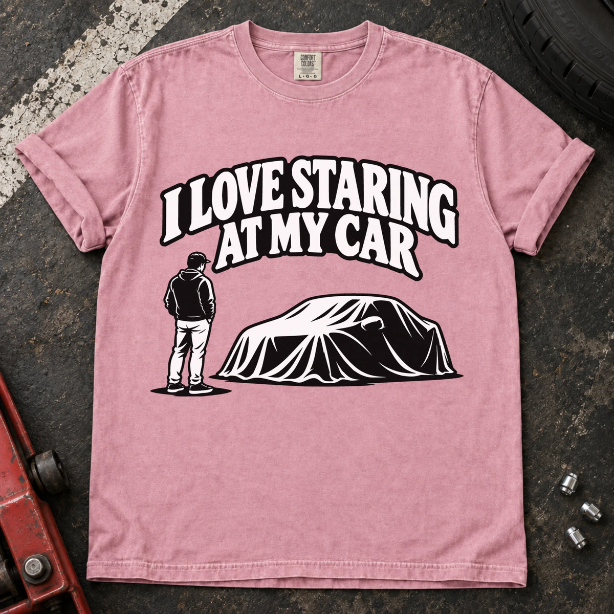 Blossom T-shirt showing a person beside a covered car under 'I love staring at my car'.