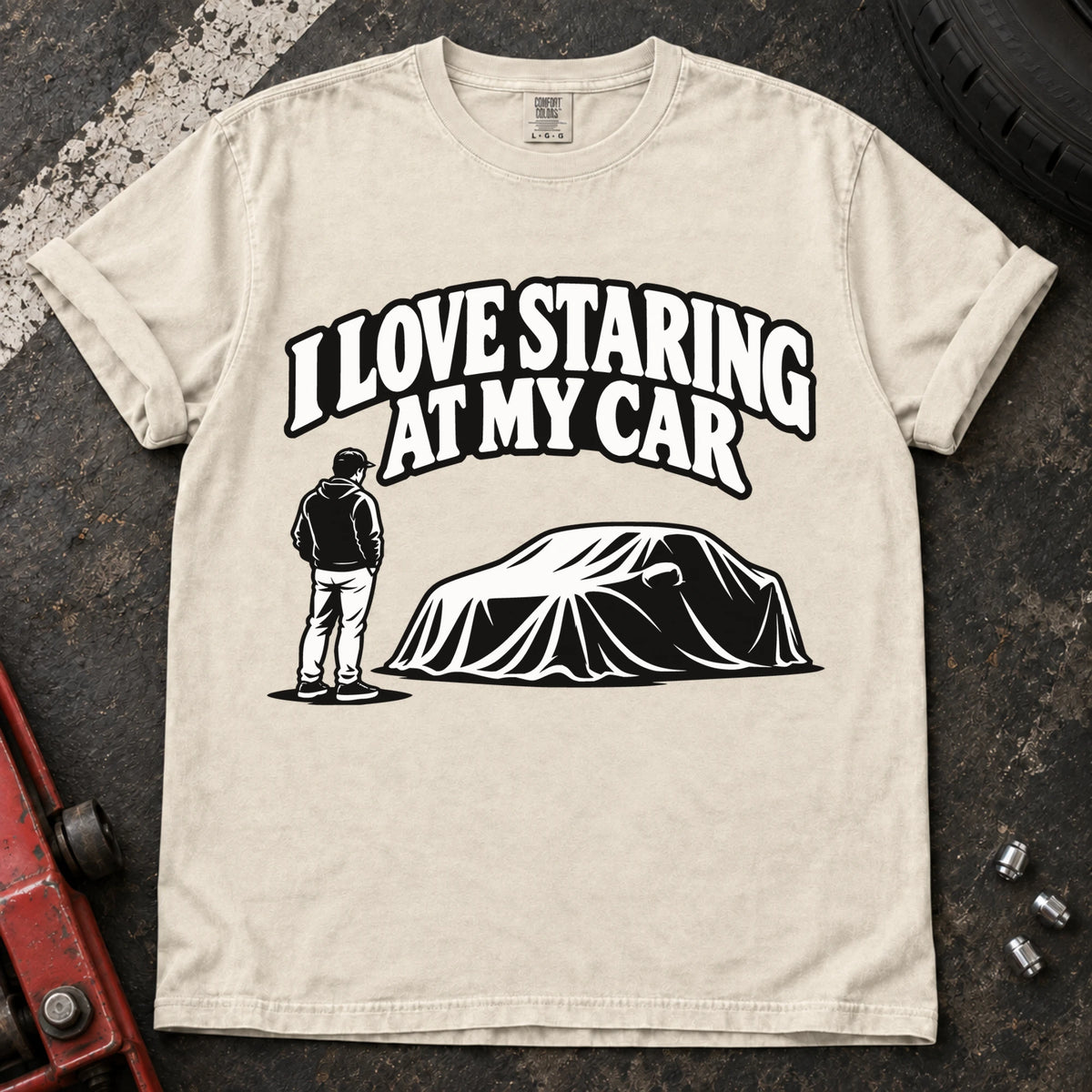 Ivory T-shirt showing a person beside a covered car under 'I love staring at my car'.