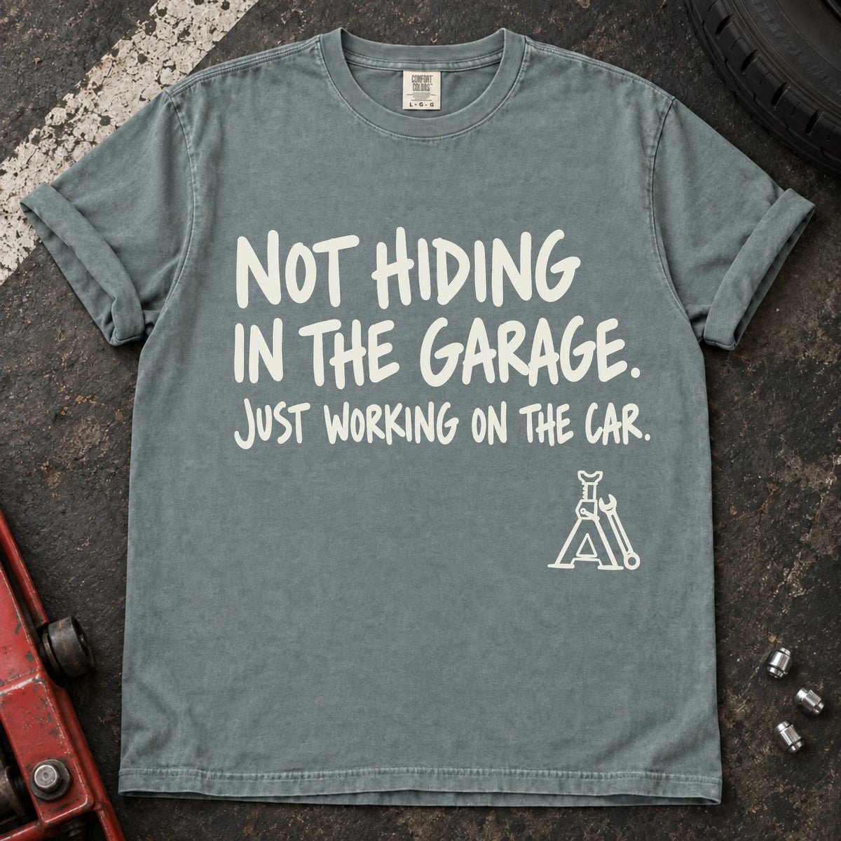 Bay car enthusiast T-shirt. A jack stand backs not hiding in the garage, just working on the car.