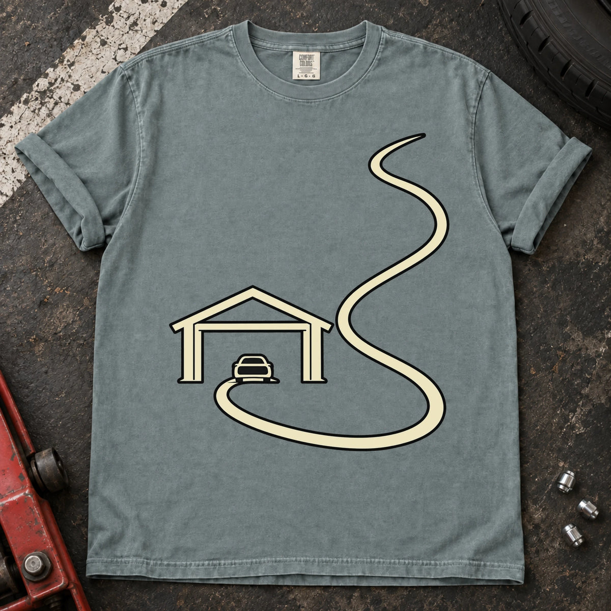 Bay car enthusiast T-shirt. A minimal garage opens onto a long winding road.