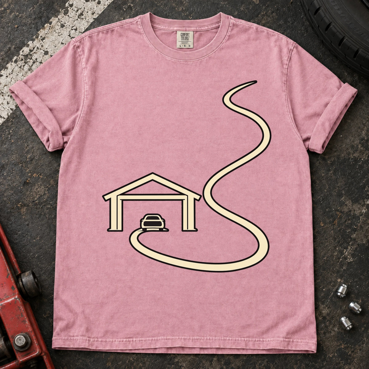 Blossom car enthusiast T-shirt. A minimal garage opens onto a long winding road.