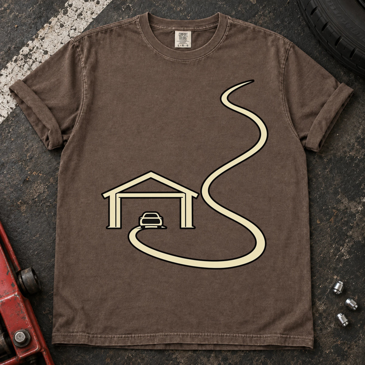 Espresso car enthusiast T-shirt. A minimal garage opens onto a long winding road.