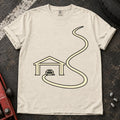 Ivory car enthusiast T-shirt. A minimal garage opens onto a long winding road.