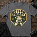 Charcoal gaming T-shirt. A loaded shopping-cart crest makes the grocery run a side mission.
