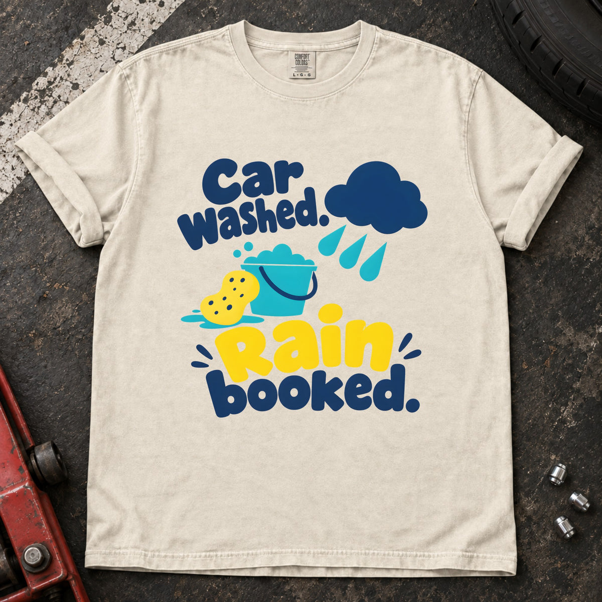 Ivory T-shirt showing a rain cloud, droplets and cleaning sponge with 'Car washed. Rain booked'.