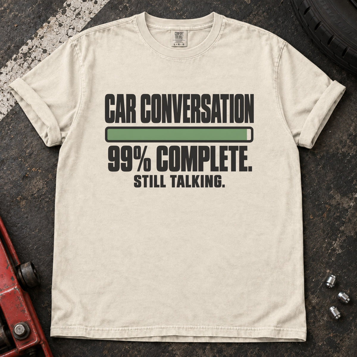 Ivory T-shirt showing a nearly full progress bar with 'Car conversation 99% complete. Still talking'.