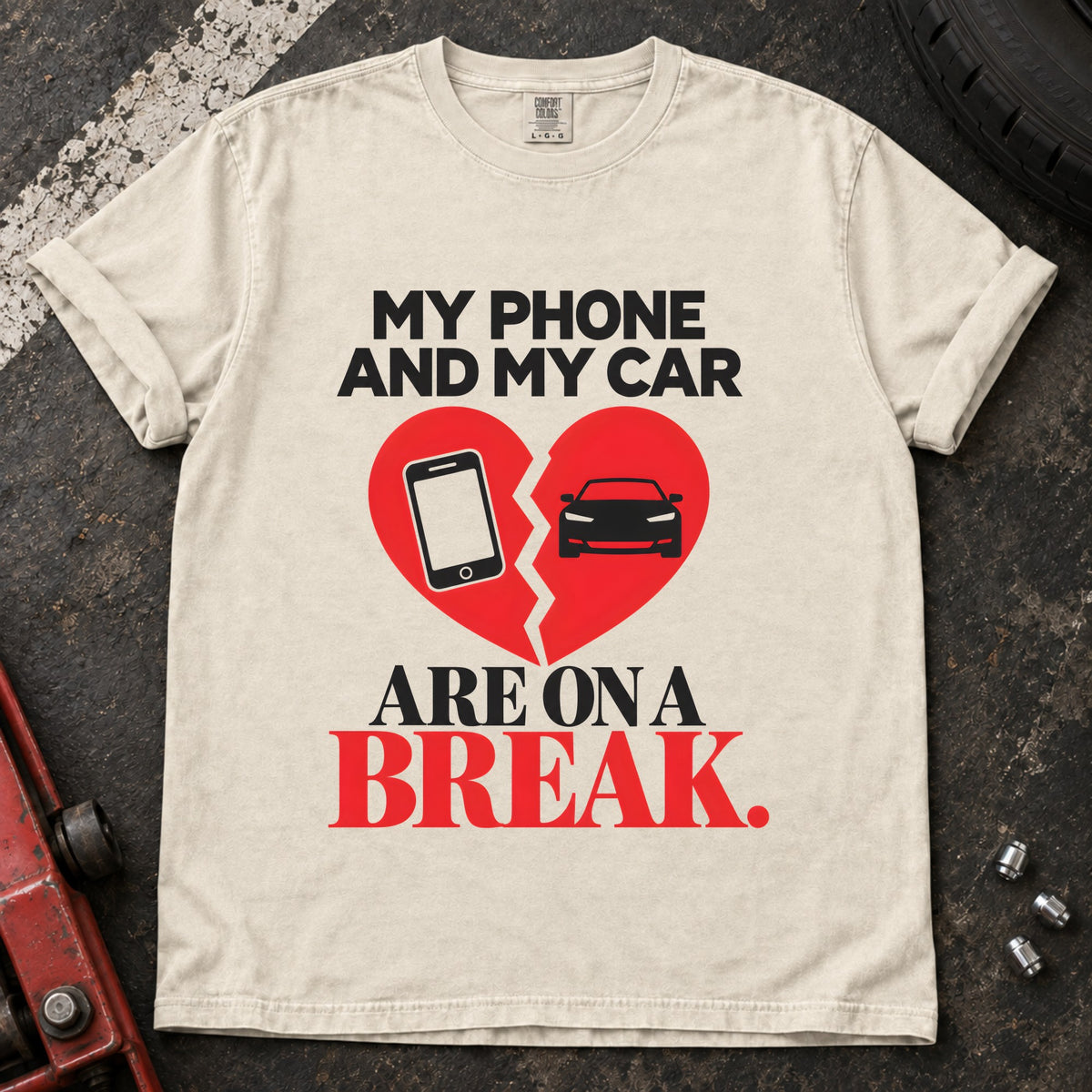 Ivory T-shirt showing a phone and car on a broken heart with 'My phone and my car are on a break'.