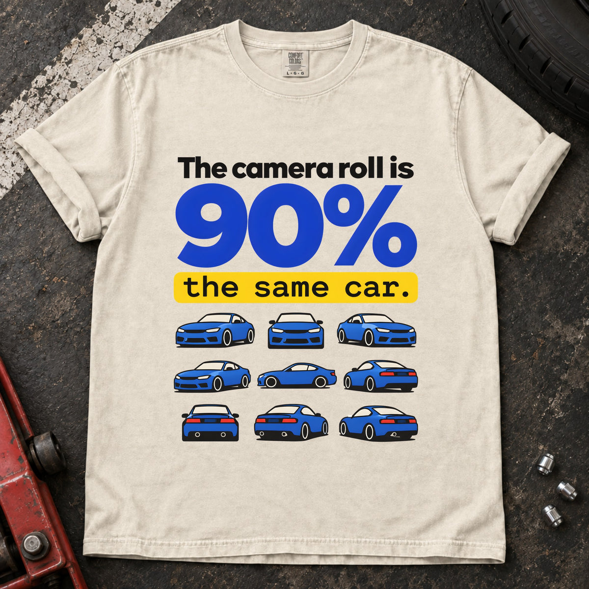 Ivory T-shirt showing a grid of small blue cars with 'The camera roll is 90% the same car'.
