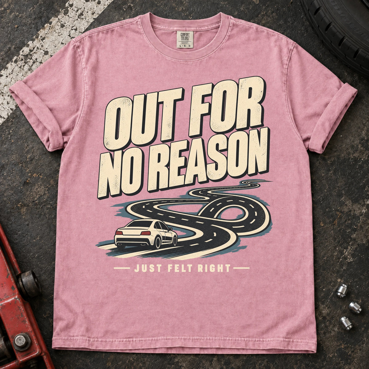 Blossom car enthusiast T-shirt. A car follows a winding road, out for no reason because it just felt right.