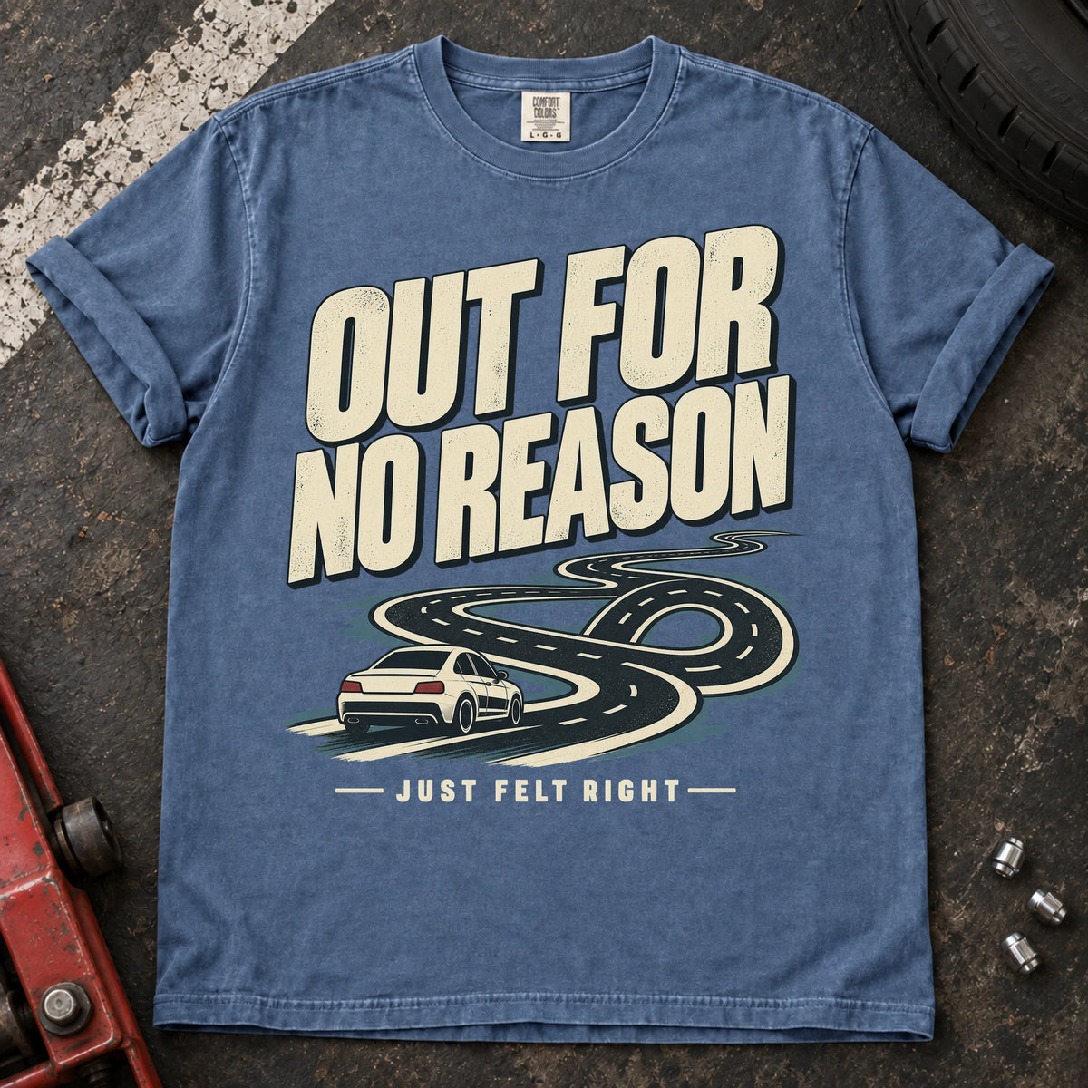 Blue Jean car enthusiast T-shirt. A car follows a winding road, out for no reason because it just felt right.