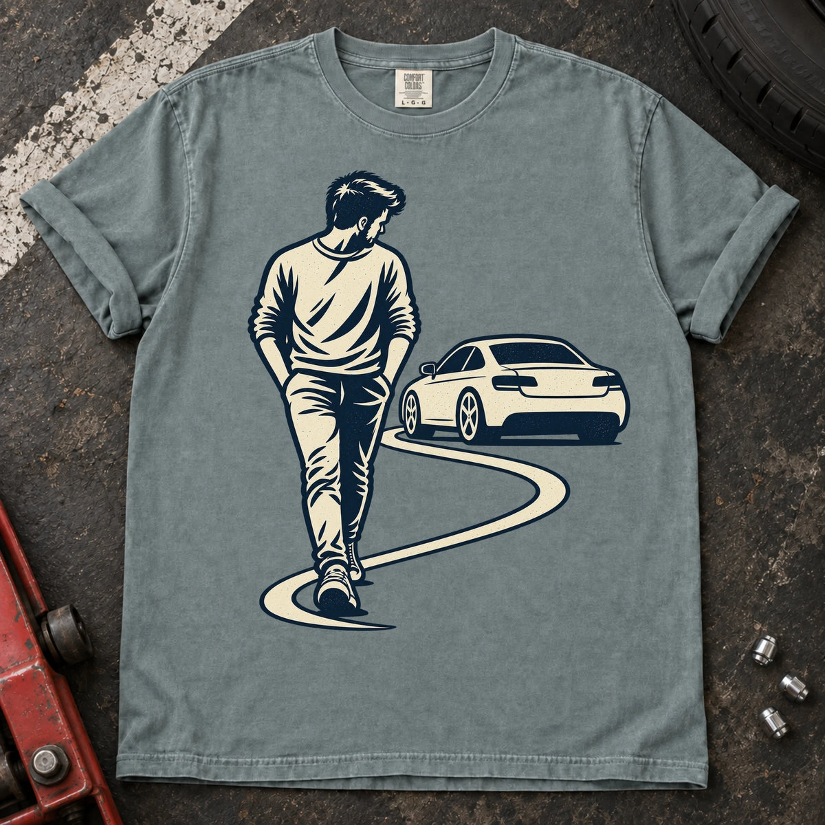 Bay car enthusiast T-shirt. A driver looks back at a parked car while walking away.