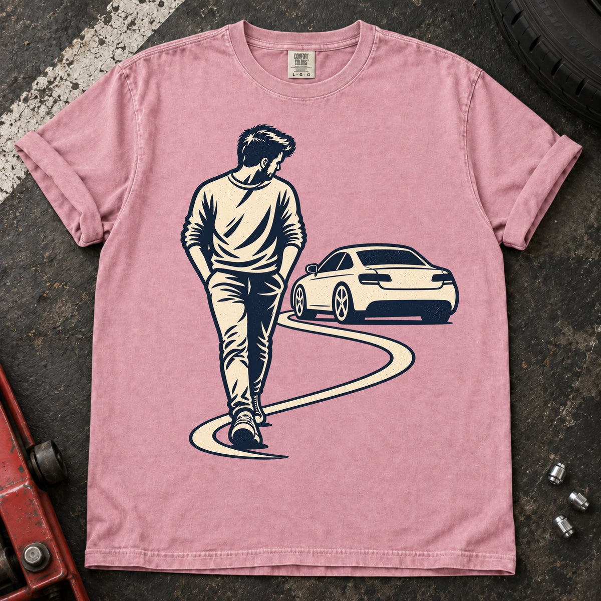 Blossom car enthusiast T-shirt. A driver looks back at a parked car while walking away.