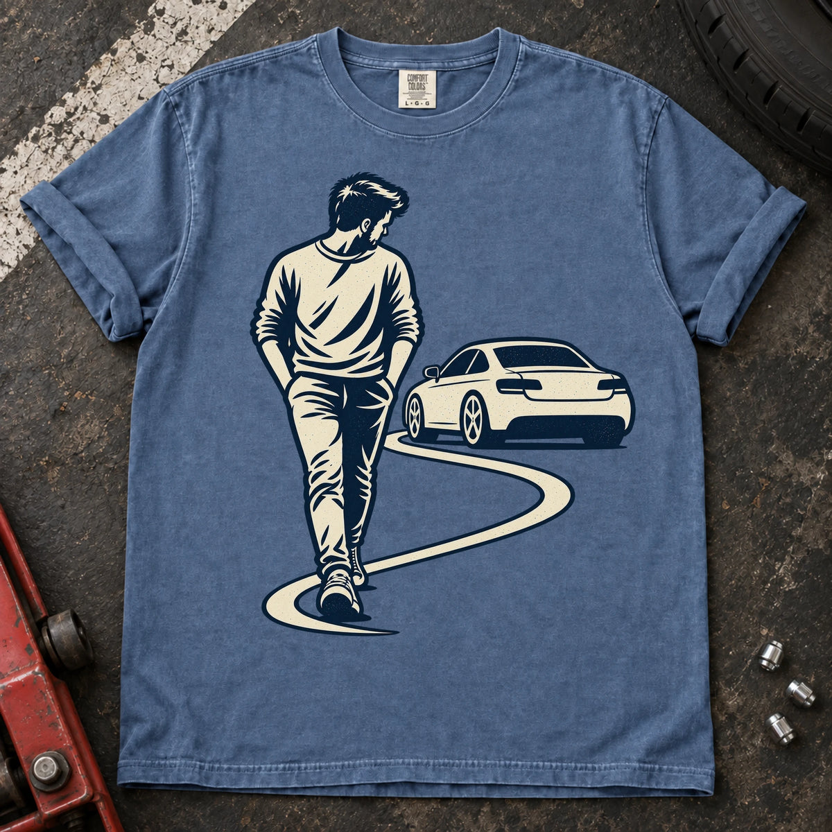 Blue Jean car enthusiast T-shirt. A driver looks back at a parked car while walking away.
