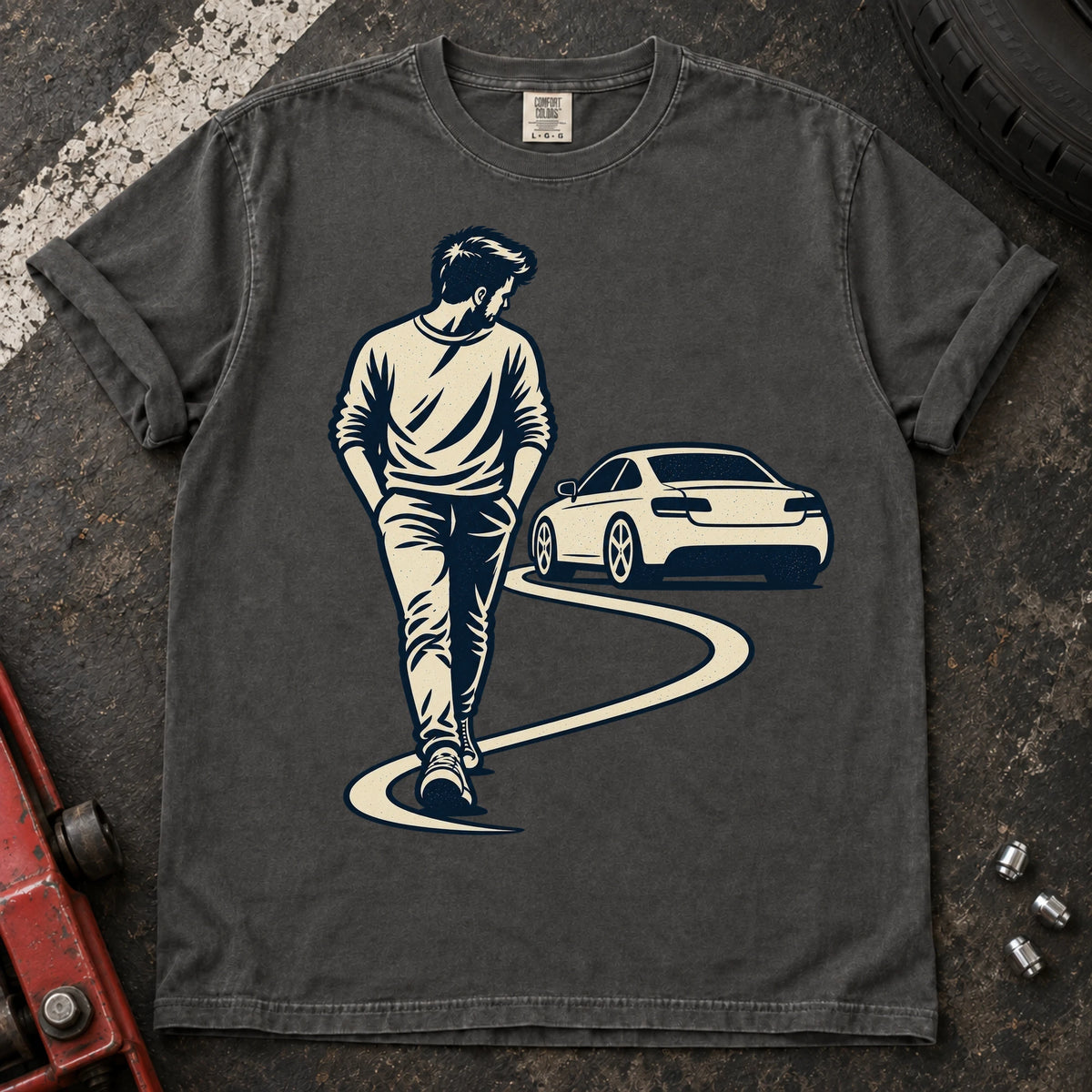 Pepper car enthusiast T-shirt. A driver looks back at a parked car while walking away.