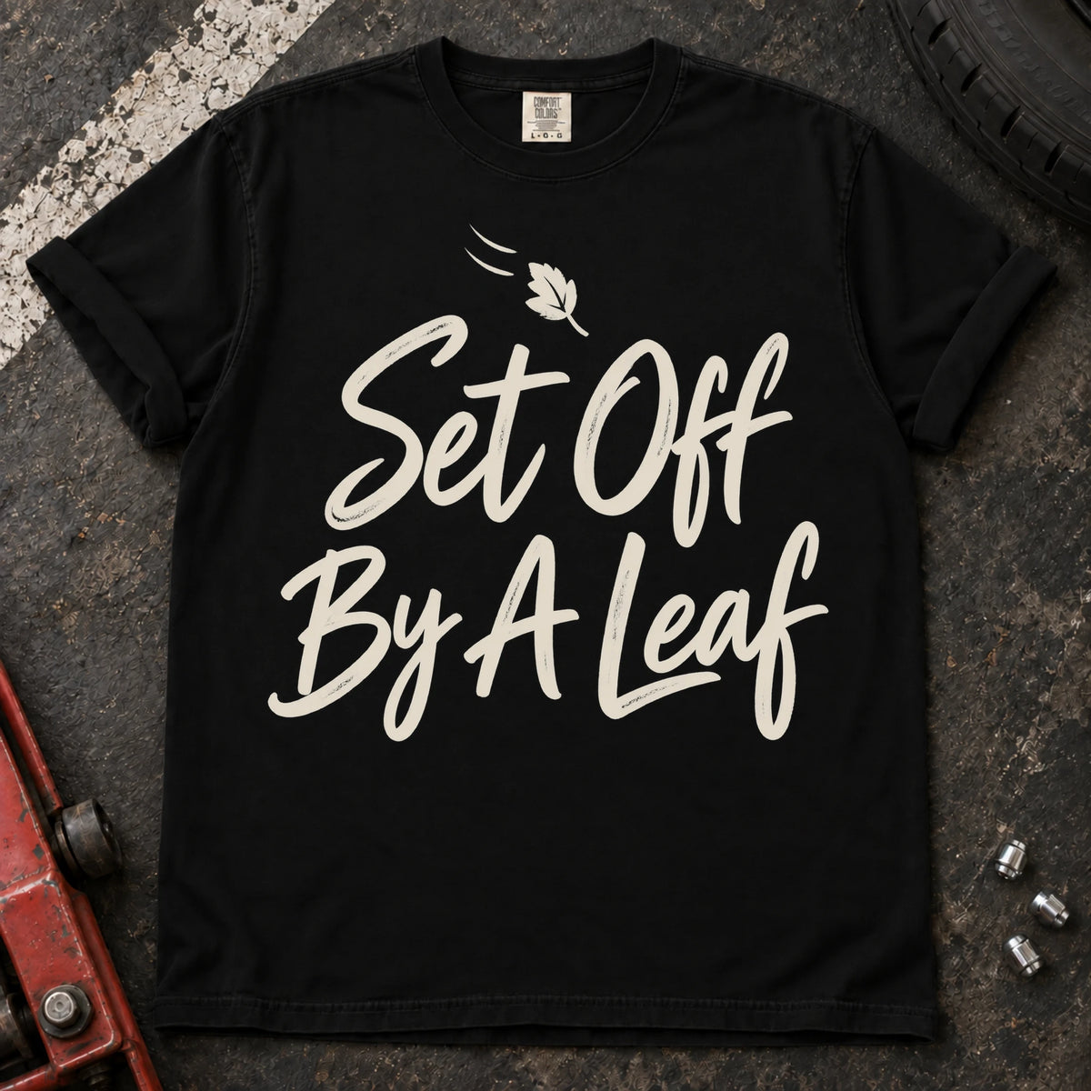 Black car enthusiast T-shirt. A falling leaf accompanies set off by a leaf.