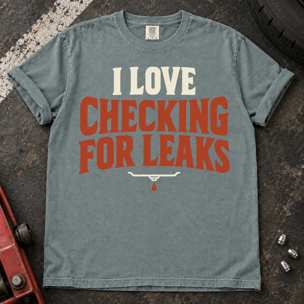 Bay T-shirt reading 'I love checking for leaks' above a small oil-pan and droplet symbol.