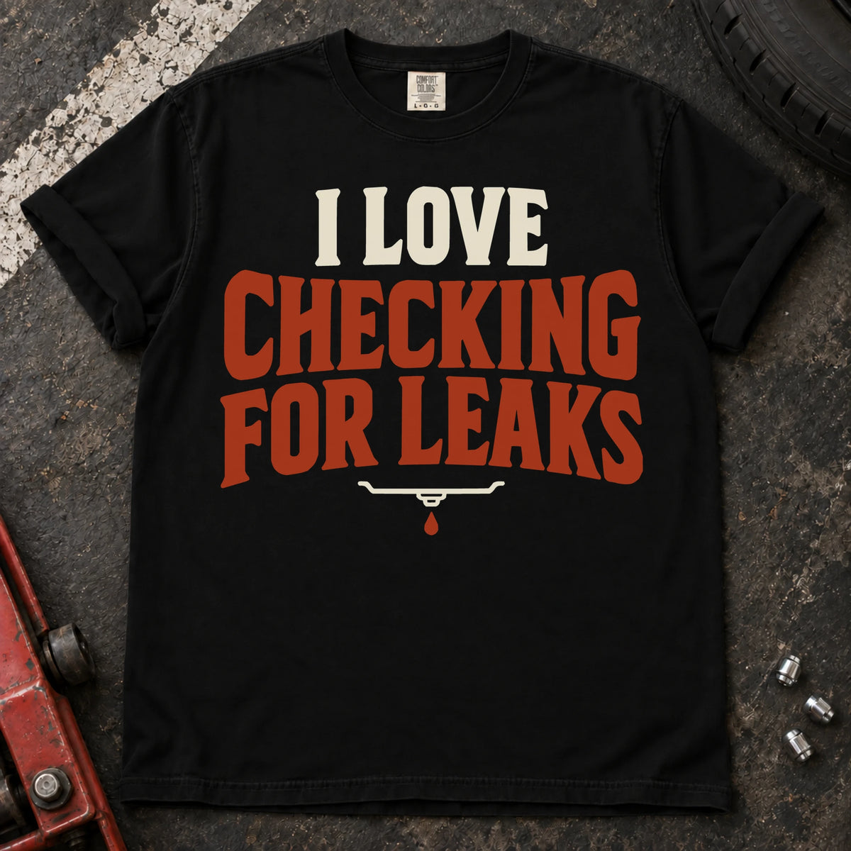 Black T-shirt reading 'I love checking for leaks' above a small oil-pan and droplet symbol.