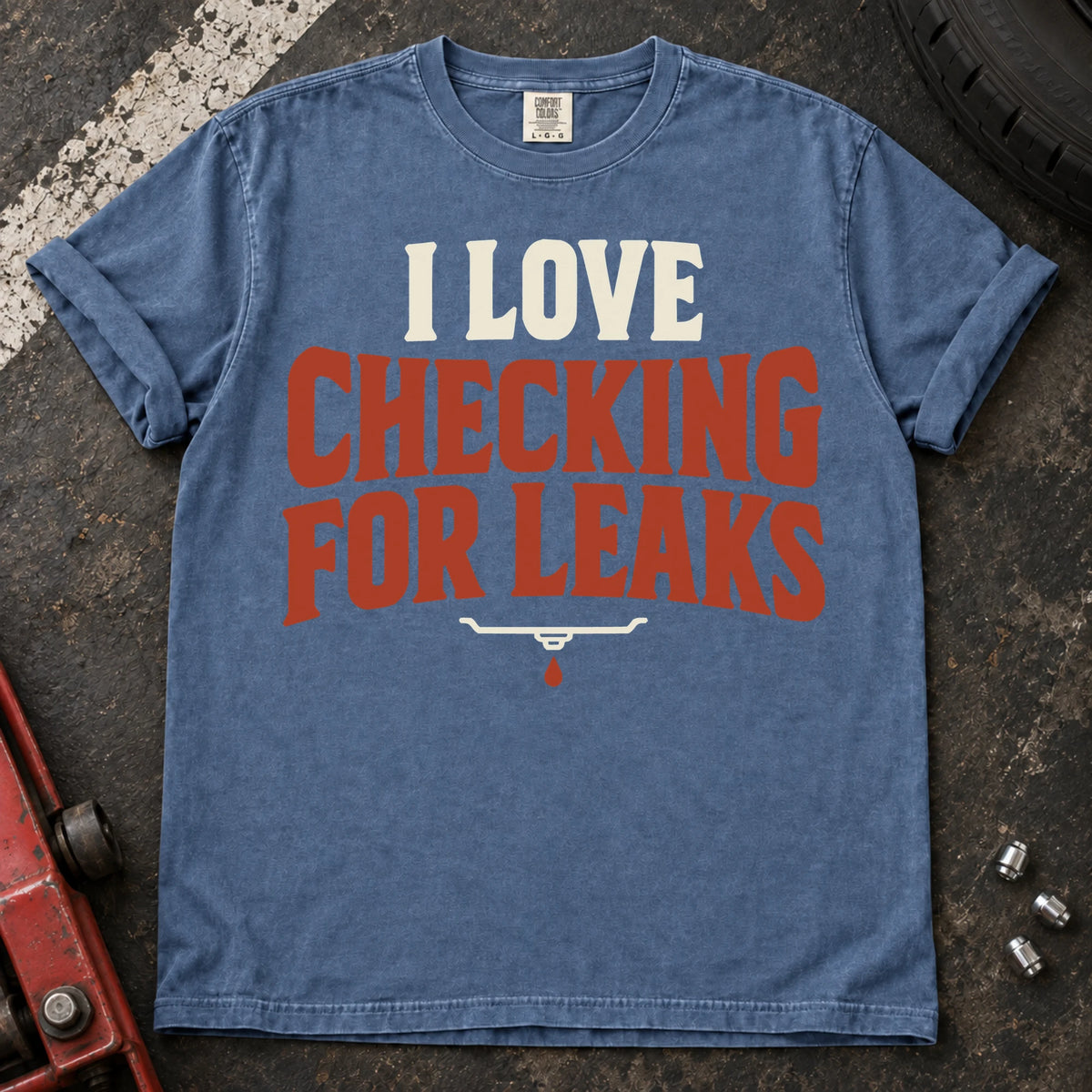 Blue Jean T-shirt reading 'I love checking for leaks' above a small oil-pan and droplet symbol.