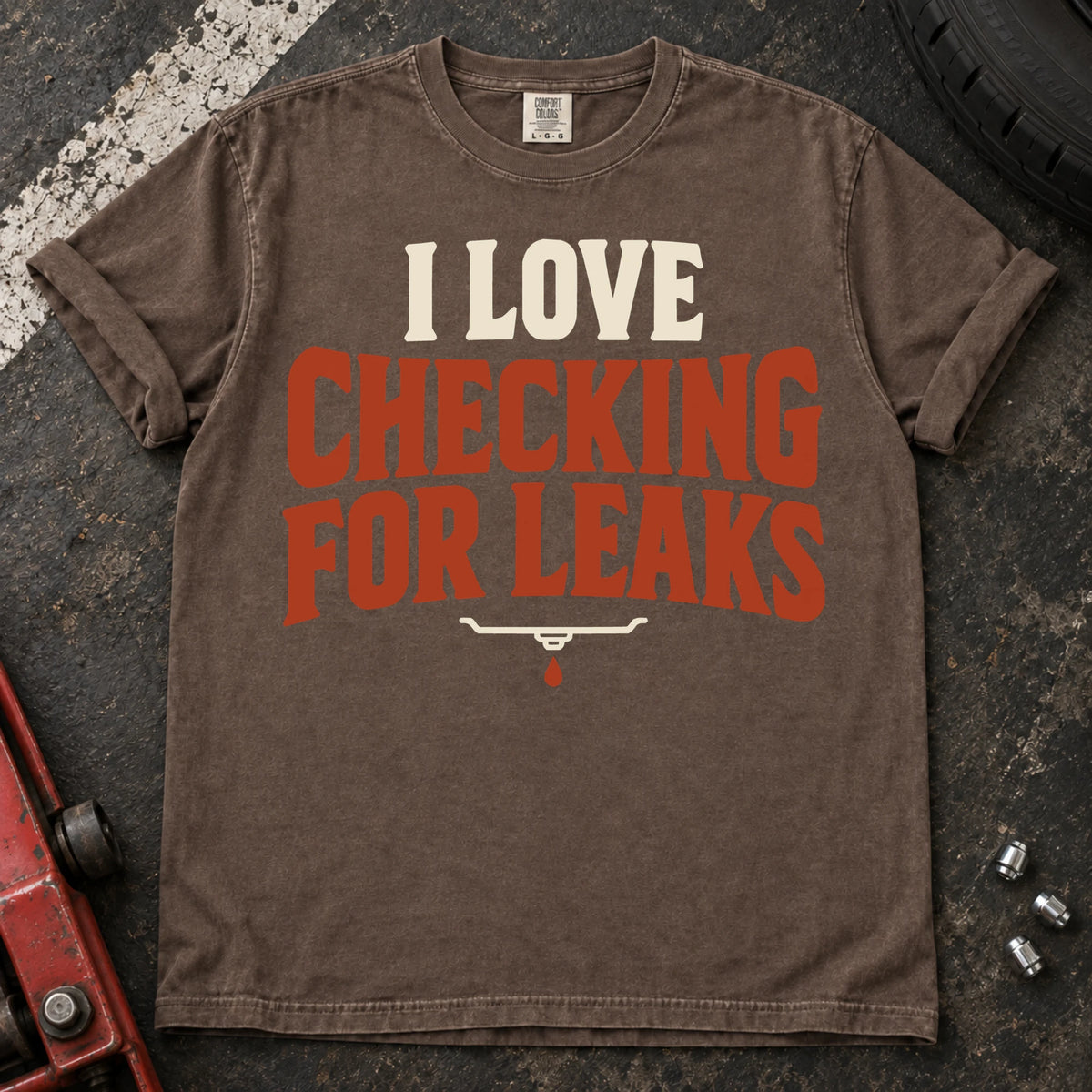 Espresso T-shirt reading 'I love checking for leaks' above a small oil-pan and droplet symbol.