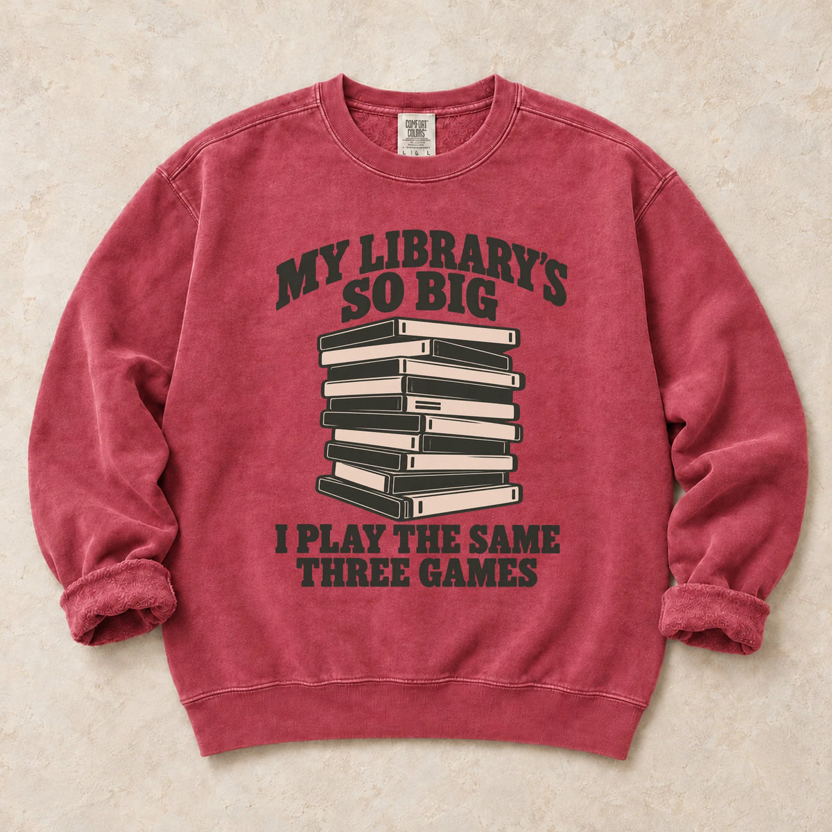 Crimson gaming sweatshirt. A huge library stack admits playing the same three games.