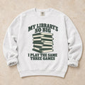 White gaming sweatshirt. A huge library stack admits playing the same three games.