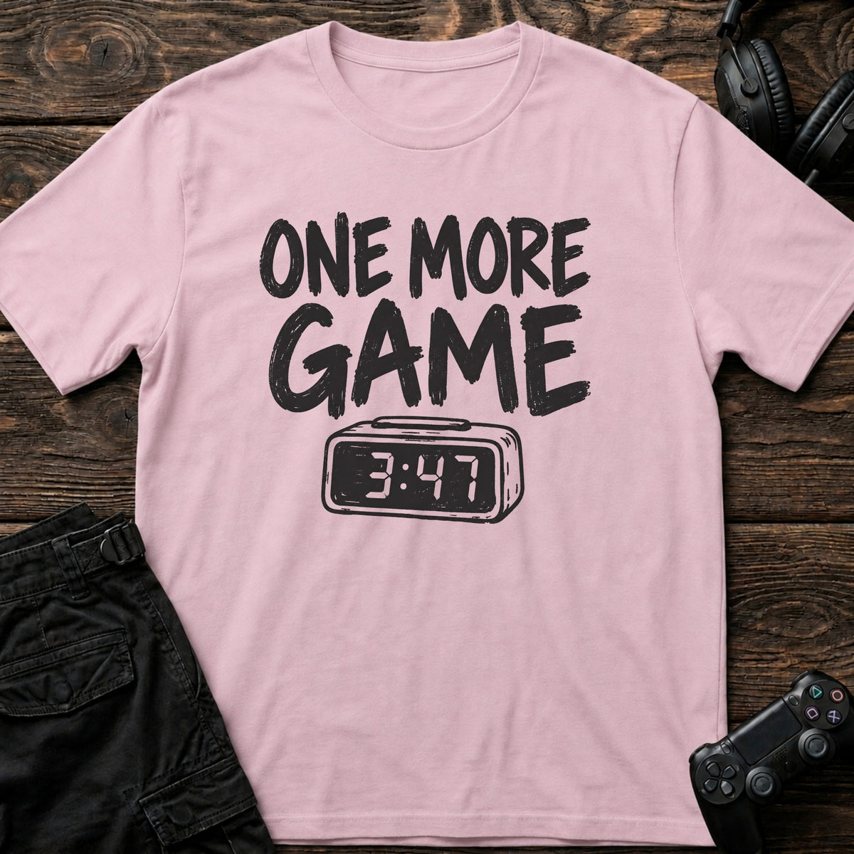 Light Pink gaming T-shirt. A digital clock nearing four accompanies the promise of one more game.