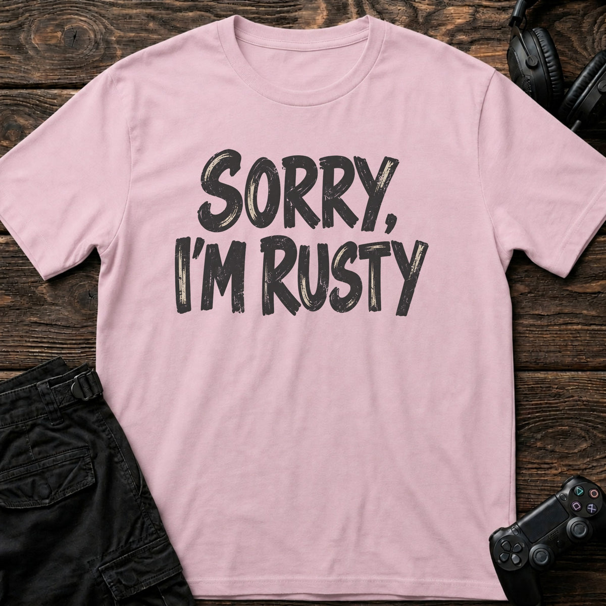 Light Pink gaming T-shirt. Sorry, I'm rusty, in bold brush-style gamer lettering.
