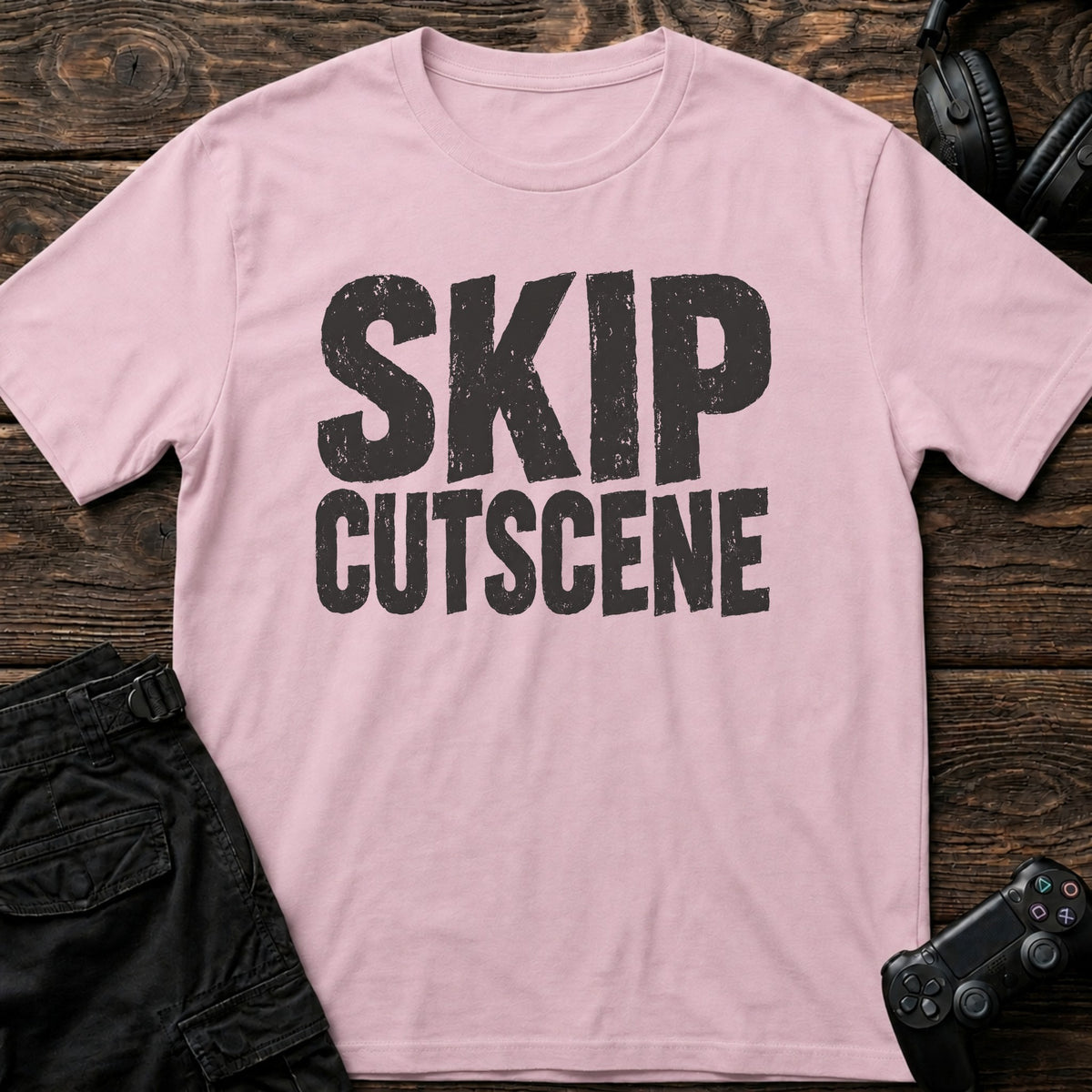 Light Pink gaming T-shirt. Skip cutscene, in worn bold lettering for impatient gamers.