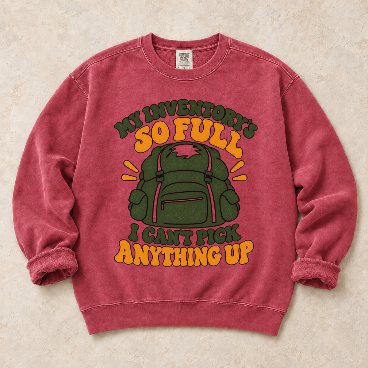 Crimson gaming sweatshirt. A stuffed backpack admits the inventory is too full to pick anything up.