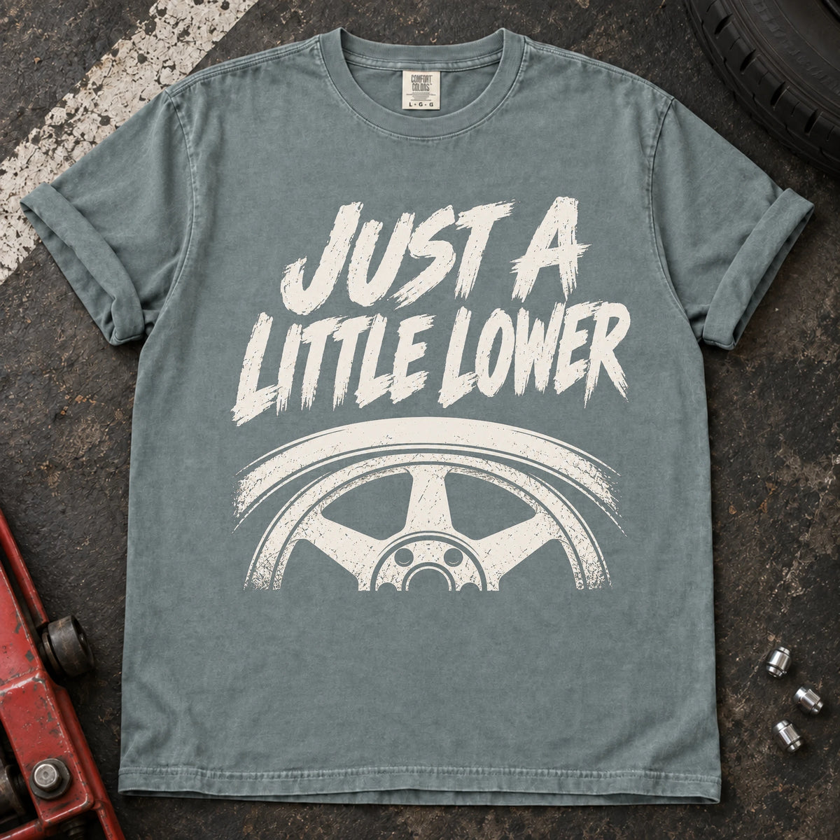 Bay car enthusiast T-shirt. A wheel tucked under a fender accompanies just a little lower.