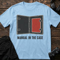 Light Blue gaming T-shirt. An open game case recalls when the manual came inside.