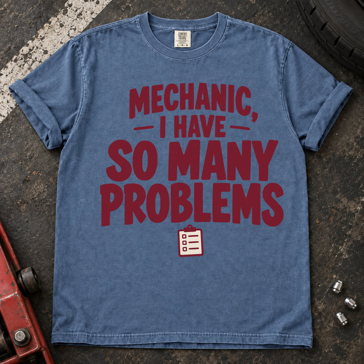 Blue Jean T-shirt with burgundy lettering reading 'Mechanic, I have so many problems' and a small checklist.