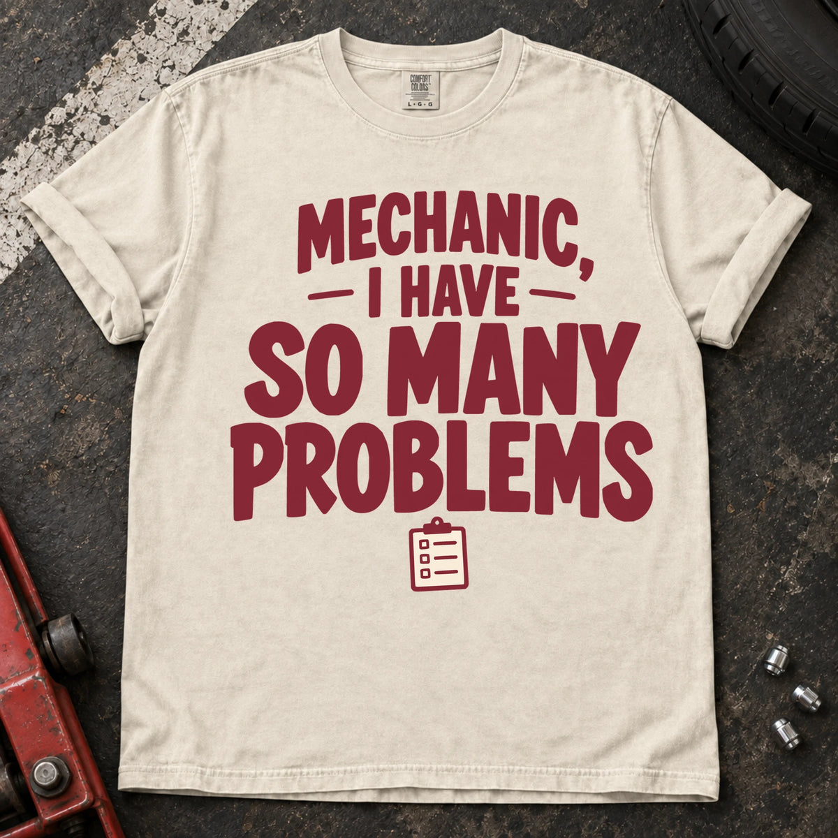 Ivory T-shirt with burgundy lettering reading 'Mechanic, I have so many problems' and a small checklist.