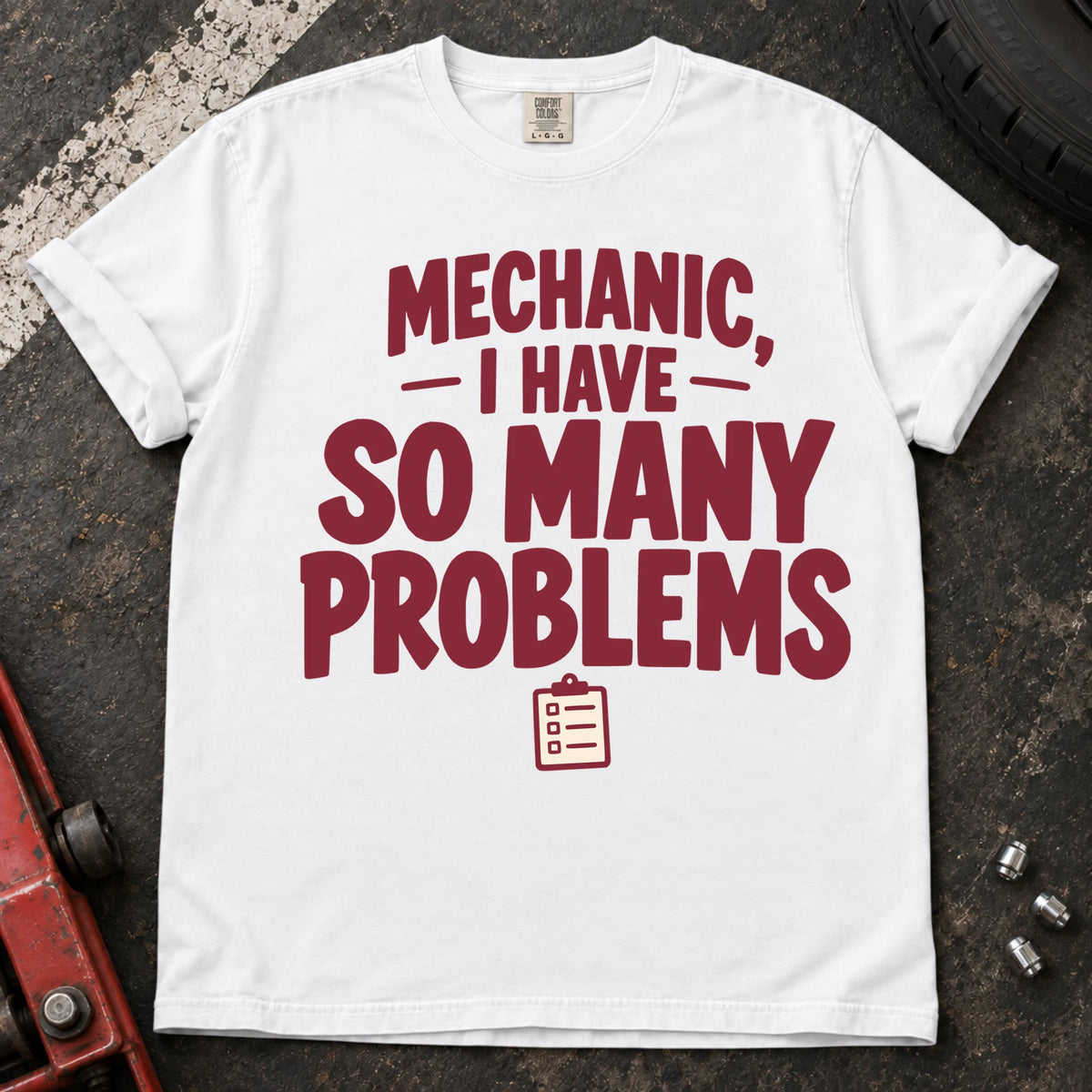 White T-shirt with burgundy lettering reading 'Mechanic, I have so many problems' and a small checklist.
