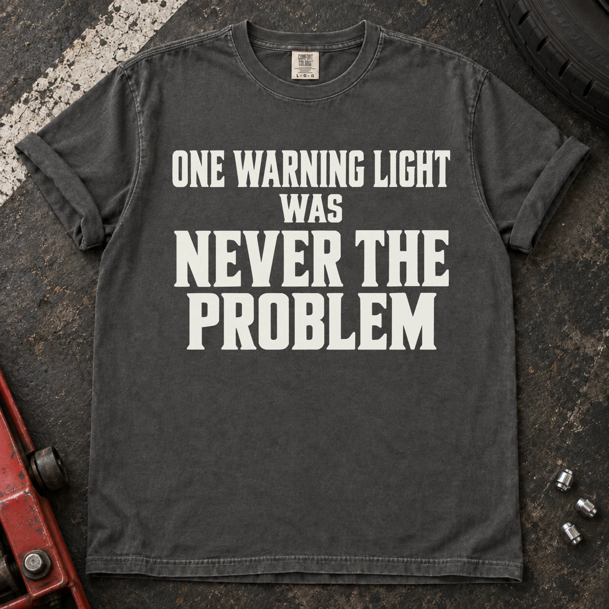 Pepper T-shirt with serif lettering reading 'One warning light was never the problem'.