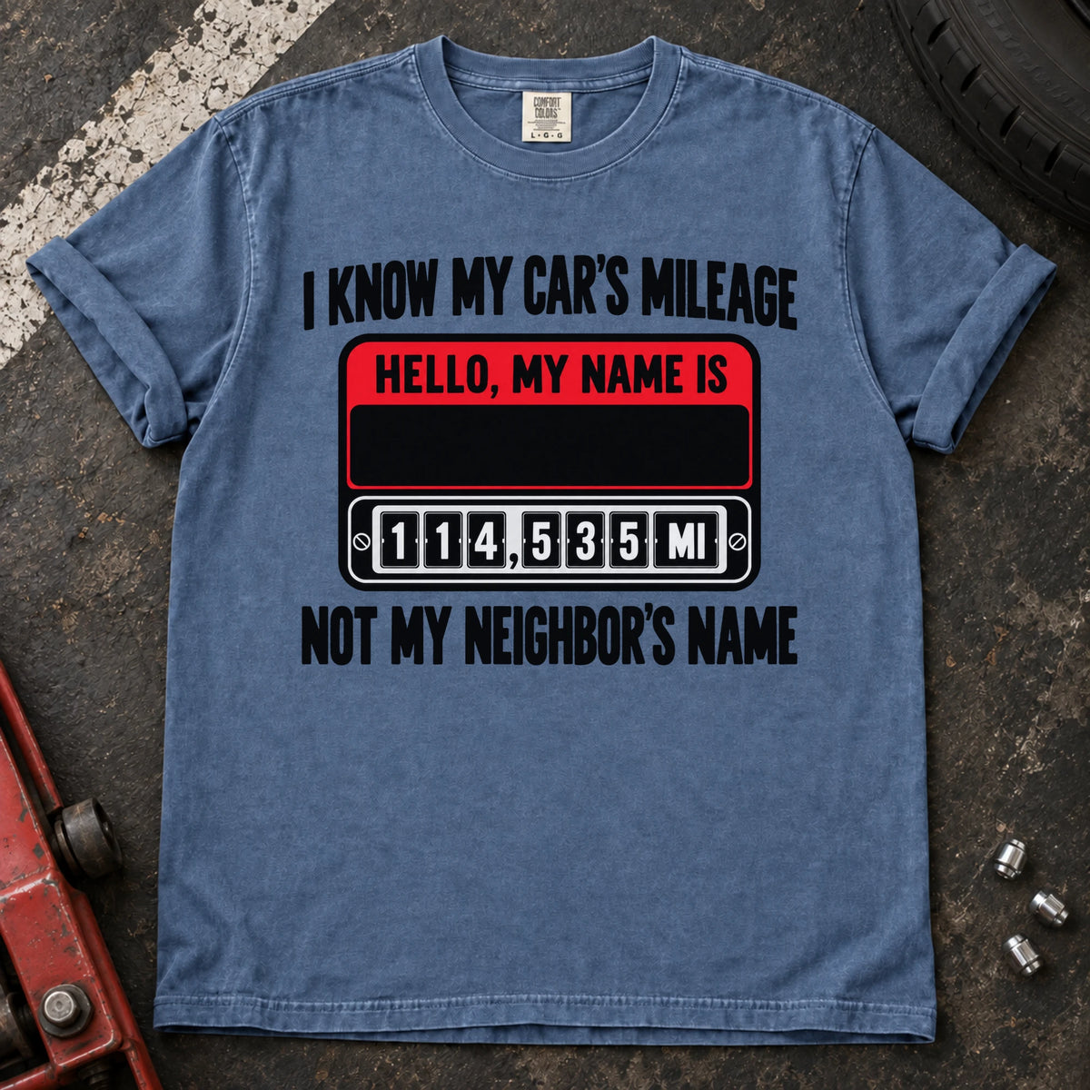 Blue Jean T-shirt showing a name badge and odometer with 'I know my car's mileage, not my neighbor's name'.