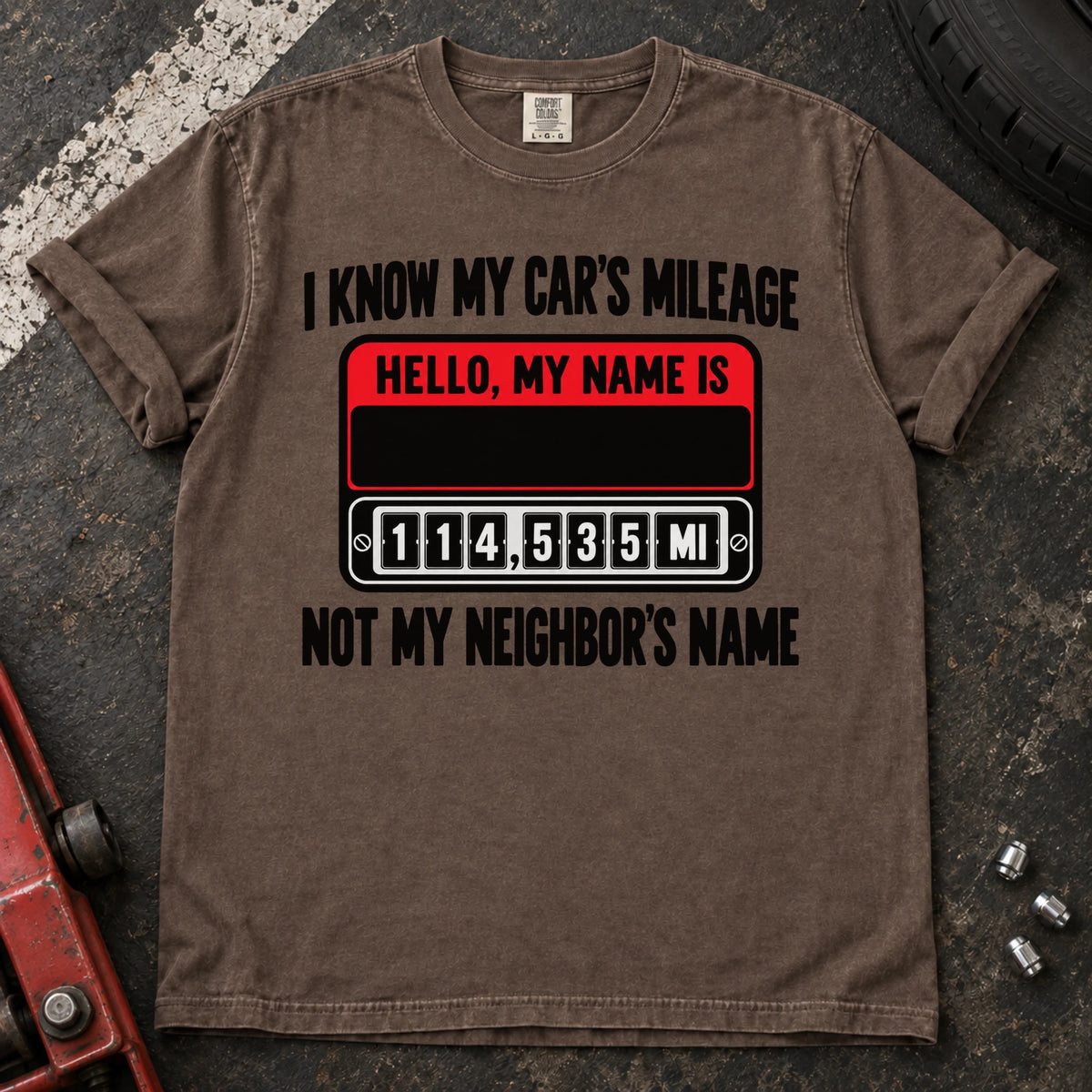 Espresso T-shirt showing a name badge and odometer with 'I know my car's mileage, not my neighbor's name'.