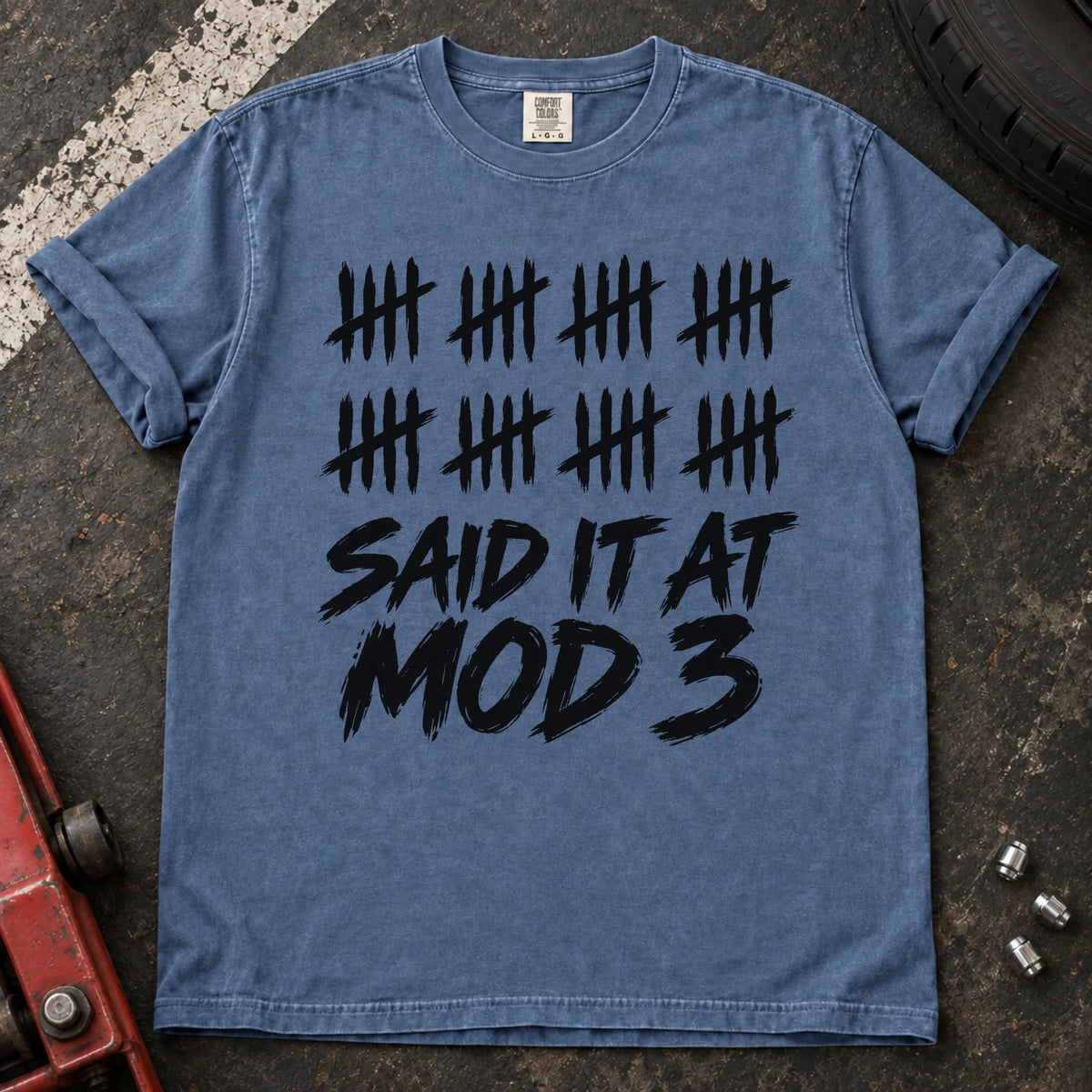 Blue Jean car enthusiast T-shirt. A long row of tally marks proves done-modifying was said at mod three.