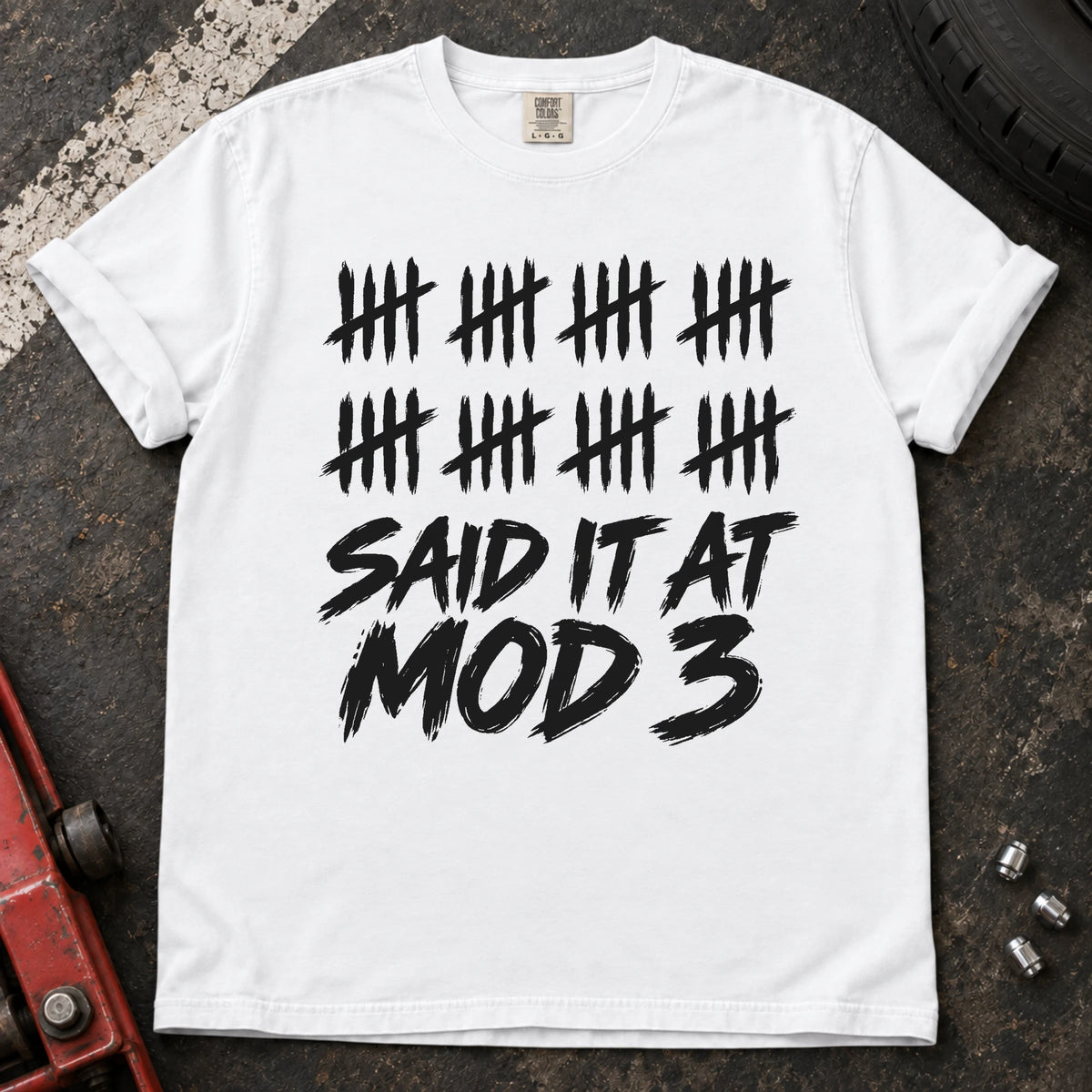 White car enthusiast T-shirt. A long row of tally marks proves done-modifying was said at mod three.