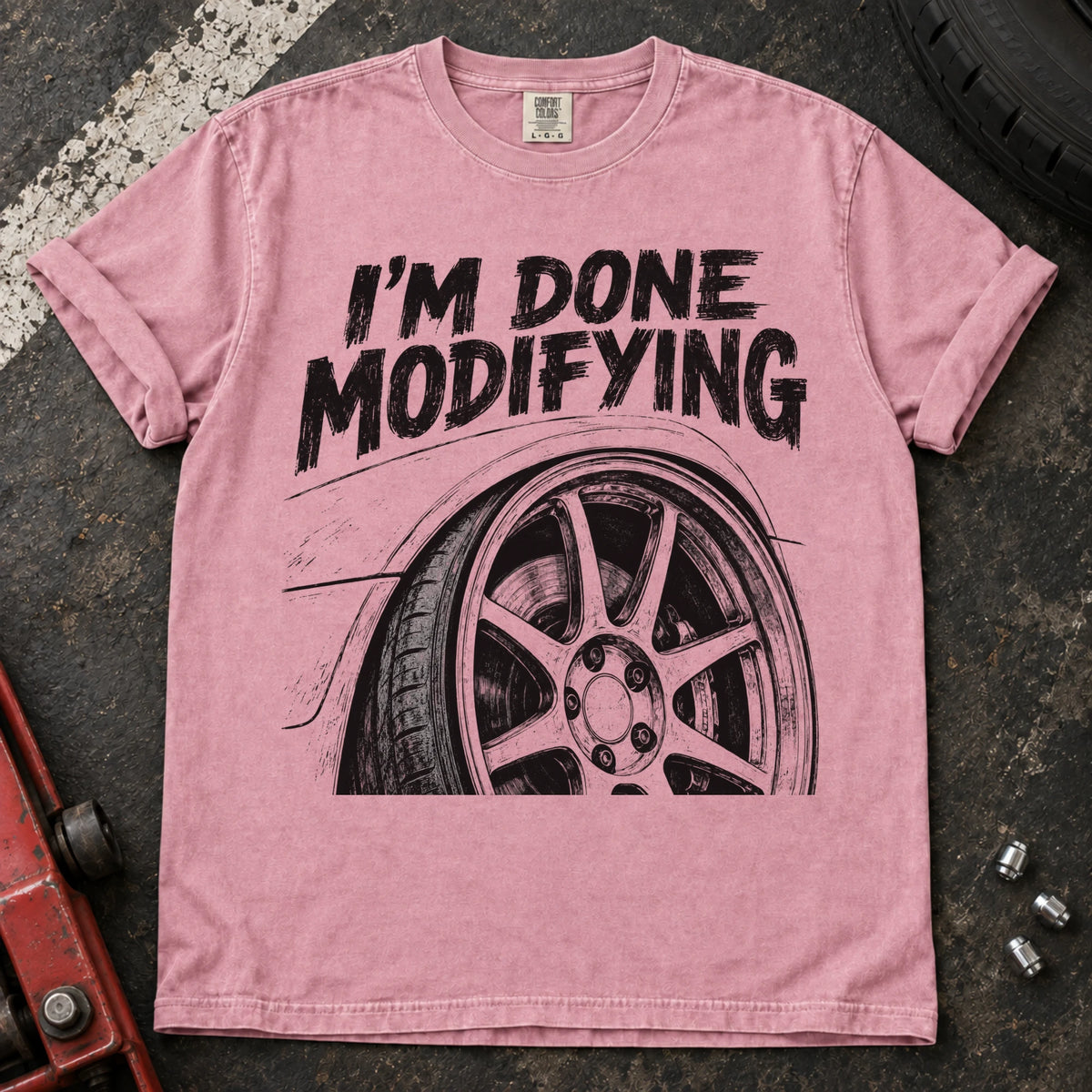 Blossom car enthusiast T-shirt. A modified wheel sits under the familiar promise, I'm done modifying.