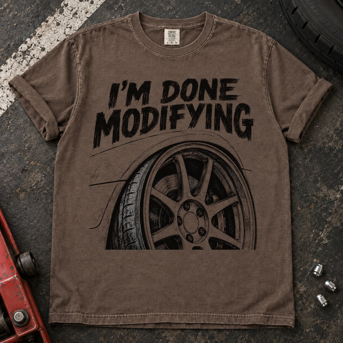 Espresso car enthusiast T-shirt. A modified wheel sits under the familiar promise, I'm done modifying.
